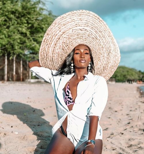Beautiful Black Woman with hat on Beach